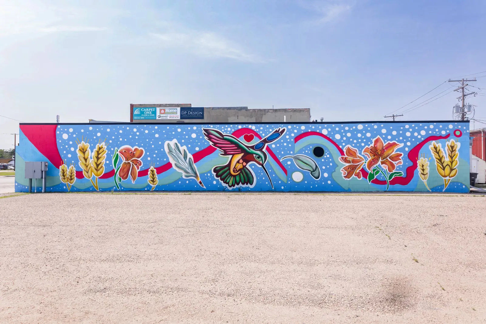 Downtown Assiniboia mural of a hummingbird among wheat and prairie lilies